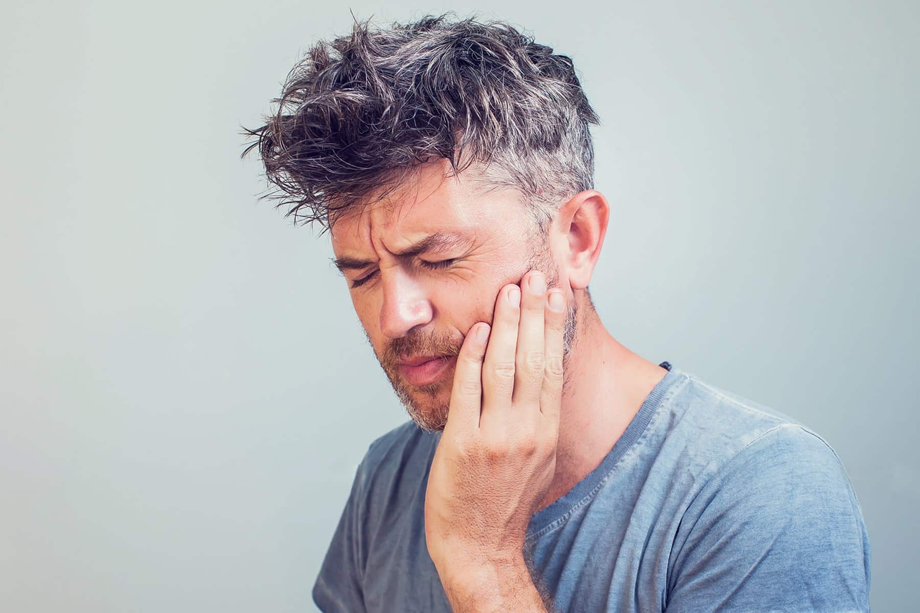 Man treating tooth pain in Savannah, GA